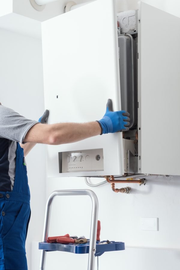 Professional engineer doing a boiler inspection at home