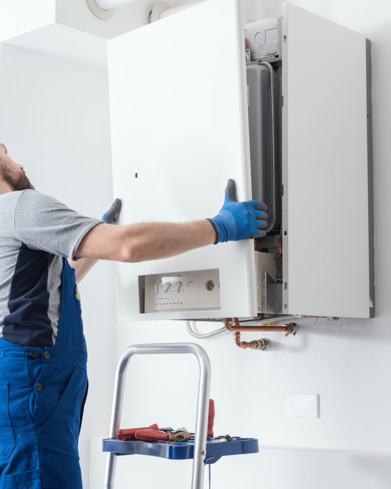 Professional engineer doing a boiler inspection at home